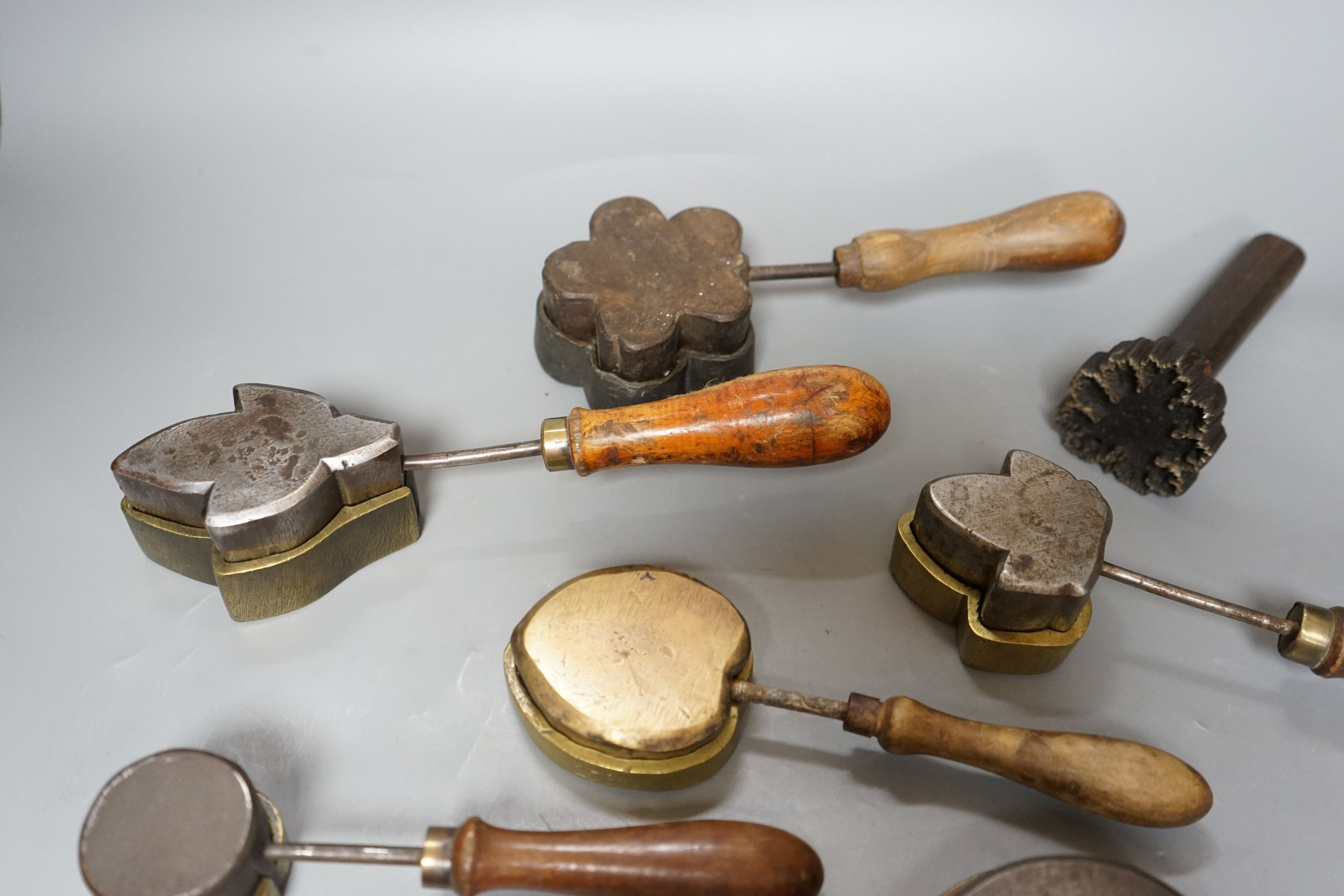 A collection of eight 19th century cast metal floral moulds, possibly for embossing silk